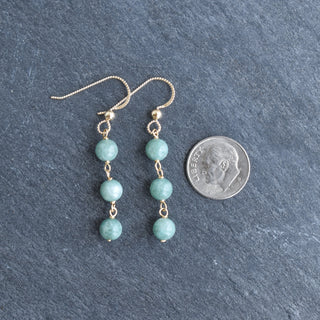 Sixmm jade dangle earrings with triple linked design from Yay Hawaii, showcasing smooth green jade stones hanging in a stylish pattern.