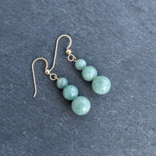 Graduated jade bead cluster earrings by Yay Hawaii featuring multiple green jade beads hanging from gold hooks.