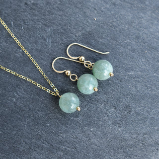 10mm jade vertical pendant necklace with gold accent bead, showcasing a sleek green jade stone and elegant gold details.