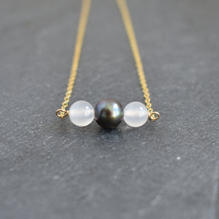White agate and black freshwater pearl necklace featuring elegant beads and a delicate clasp, designed by Yay Hawaii.