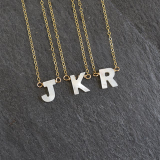 Mother of Pearl initial necklace by Yay Hawaii featuring a polished pearl pendant with an initial charm.