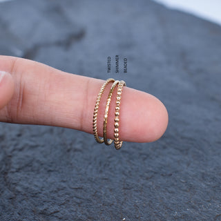 Yay Hawaii Wili Twist Stacking Ring featuring a twisted gold band and intricate design, perfect for layered jewelry styles.