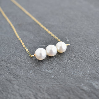 Yay Hawaii triple 8mm white pearl necklace with round pearls on a delicate strand, elegant jewelry accessory.