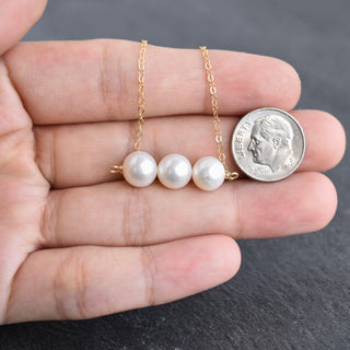 Yay Hawaii white pearl necklace with three strands of 8mm pearls, elegant jewelry accessory on a neutral background.