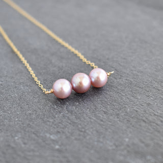 Yay Hawaii light pink and purple pearl necklace with 8mm pearls, elegant jewelry piece on a white background.