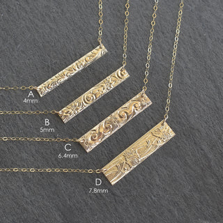 Hawaiian heirloom style patterned bar necklace by Yay Hawaii, featuring intricate Polynesian-inspired designs on a silver chain.