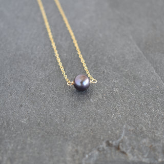 Black 8mm freshwater pearl station bar necklace by Yay Hawaii, featuring a sleek design with evenly spaced pearls on a delicate chain.