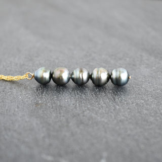 Tahitian pearl vertical pendant necklace by Yay Hawaii featuring a sleek black pearl on a delicate chain.