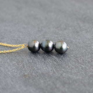 Vertical pendant necklace featuring three Tahitian pearls on a silver chain, showcasing elegant jewelry by Yay Hawaii.
