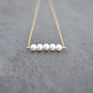 Tiny 4mm white seed pearl station necklace by Yay Hawaii, featuring small white pearl beads on a delicate chain.