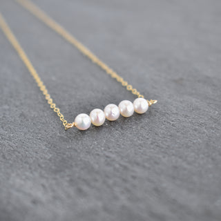 Tiny 4mm white seed pearl station necklace by Yay Hawaii featuring small, uniform pearl beads on a delicate chain.