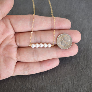 Tiny 4mm white seed pearl station necklace by Yay Hawaii, featuring small, round pearl beads on a delicate chain.