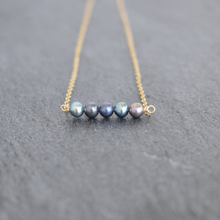 Tiny 4mm peacock seed pearl station necklace by Yay Hawaii, featuring small iridescent pearl beads on a delicate chain.