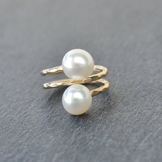 White pearl double bypass ring by Yay Hawaii featuring two overlapping bands with lustrous pearls on a sleek silver band.