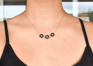 Black pearl station necklace by Yay Hawaii featuring three black pearls on a delicate chain, close-up view of the jewelry.