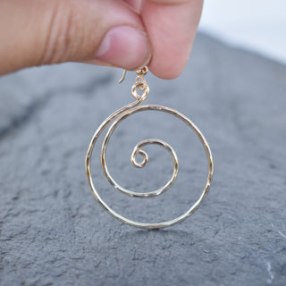 Large Yay Hawaii spiral earrings with a sleek, modern design, showcasing smooth, shiny metallic loops.