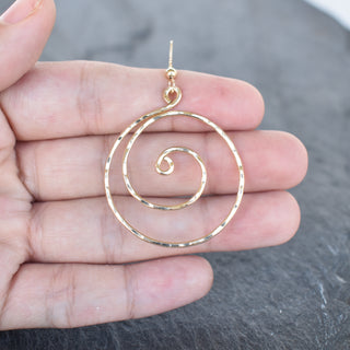 Large spiral earrings by Yay Hawaii with a sleek, modern design featuring smooth, curved metal loops.