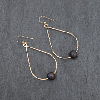 Large black pearl teardrop hoop earrings by Yay Hawaii featuring elegant teardrop-shaped black pearls and hoop design.