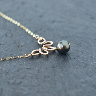 Small Naupaka necklace from Yay Hawaii featuring a delicate floral pendant on a woven cord.