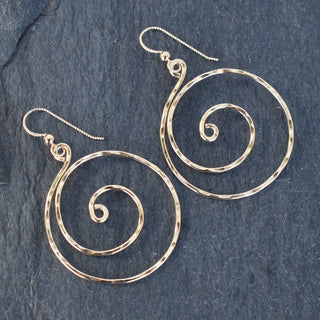 Large spiral earrings by Yay Hawaii featuring bold, metallic loops hanging from ear hooks, stylish and modern jewelry accessory.