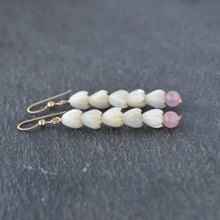 Five small mother of pearl Pikake flowers with 6mm rose quartz beads on long earrings by Yay Hawaii.