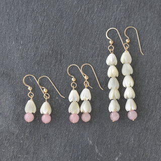 Five small mother of pearl Pikake flowers and 6mm rose quartz long earrings by Yay Hawaii, showcasing delicate jewelry design.