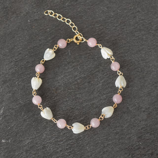 Linked 6mm rose quartz and small pikake bracelet by Yay Hawaii, featuring elegant pink quartz beads and delicate floral accents.