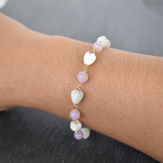 Linked 6mm rose quartz and small pikake bracelet by Yay Hawaii, showcasing pink quartz beads and delicate floral accents.