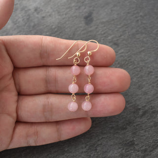 Triple linked 6mm rose quartz earrings with gold hooks from Yay Hawaii, showcasing elegant gemstone jewelry on a white background.