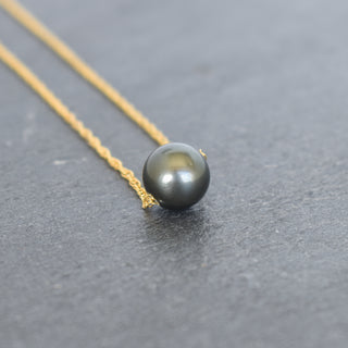 Round Tahitian pearl pendant on a double rope chain necklace by Yay Hawaii, close-up view highlighting the lustrous dark pearl.