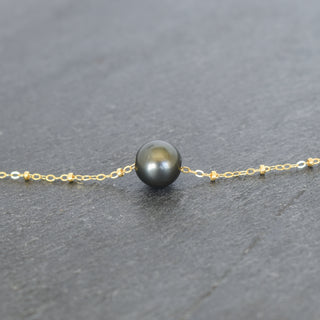 Round Tahitian pearl pendant with satellite chain necklace from Yay Hawaii, showcasing a lustrous black pearl on a delicate silver chain.