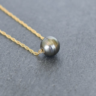 Tahitian pearl circle pendant on a double rope chain necklace by Yay Hawaii, featuring a lustrous dark pearl and intricate chain details.