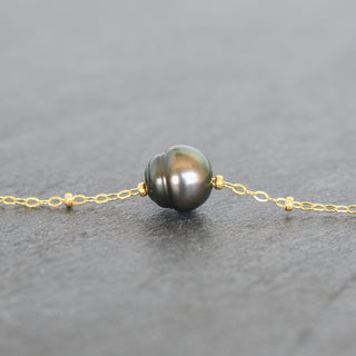 Tahitian pearl circle pendant with satellite chain necklace from Yay Hawaii, showcasing a round black pearl on a delicate silver chain.