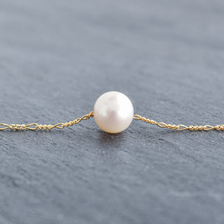 White freshwater pearl necklace with Figaro chain by Yay Hawaii, showcasing elegant jewelry design and shiny pearl accents.