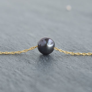 Black freshwater pearl necklace with double rope chain by Yay Hawaii, featuring elegant black pearls on a stylish chain.