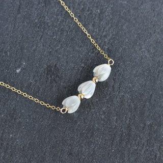 Triple small Mother of Pearl Pikake bar necklace by Yay Hawaii with metal accent beads, featuring delicate floral-inspired design.