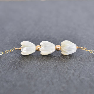 Triple small Mother of Pearl Pikake Bar necklace with metal accent beads, featuring delicate floral design from Yay Hawaii.