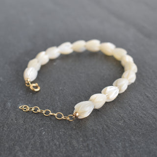 Colorful Pikake bracelet by Yay Hawaii, suitable for adults or children, featuring white jasmine flower beads on a flexible band.