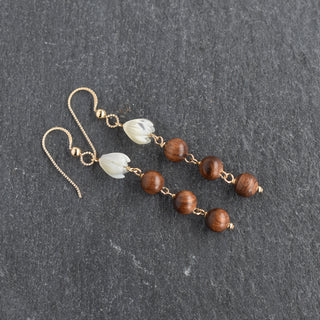 Dangling mother of pearl Pikake earrings with triple rosewood beads, handcrafted jewelry by Yay Hawaii.