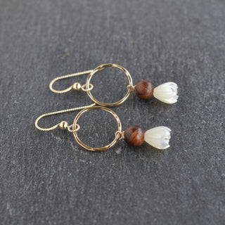 Small hoop earring from Yay Hawaii with a dangling mother of pearl Pikake flower and rosewood accents.