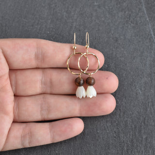 Small hoop earring by Yay Hawaii featuring a dangling mother of pearl Pikake flower and rosewood accents.