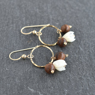 Small hoop earrings featuring mother of pearl Pikake flowers and rosewood beads, by Yay Hawaii, close-up view.