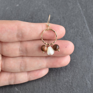 Small hoop earrings featuring mother of pearl Pikake and rosewood beads by Yay Hawaii, hanging with intricate bead details.