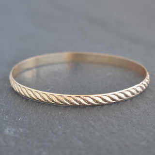 Yay Hawaii Ulana weave pattern textured bangle showcasing intricate woven design and smooth metal finish on a neutral background.