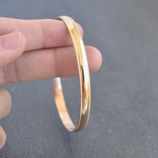Yay Hawaii Malino smooth patterned bangle bracelet with intricate design on silver-tone metal, stylish accessory for any outfit.