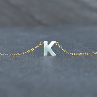 Mother of Pearl initial necklace by Yay Hawaii featuring a polished pearl pendant with a gold chain.