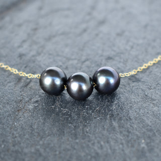 Black pearl floating necklace featuring 9-9.5mm pearls by Yay Hawaii, showcasing the elegant design and lustrous pearls.