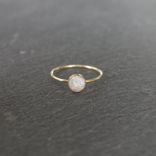 Elegant opal ring from Yay Hawaii featuring a shimmering, colorful opal gemstone set in a sleek metal band.