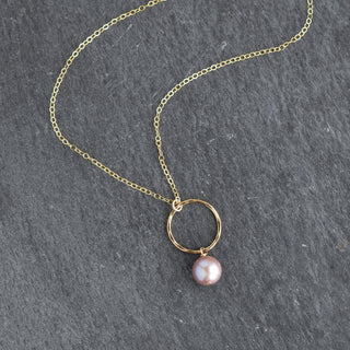Small hoop necklace by Yay Hawaii featuring a light purple pearl charm on a delicate gold chain.