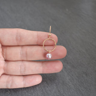 Small hoop earrings by Yay Hawaii with light purple pearls, featuring delicate gold hoops and elegant pearl accents.